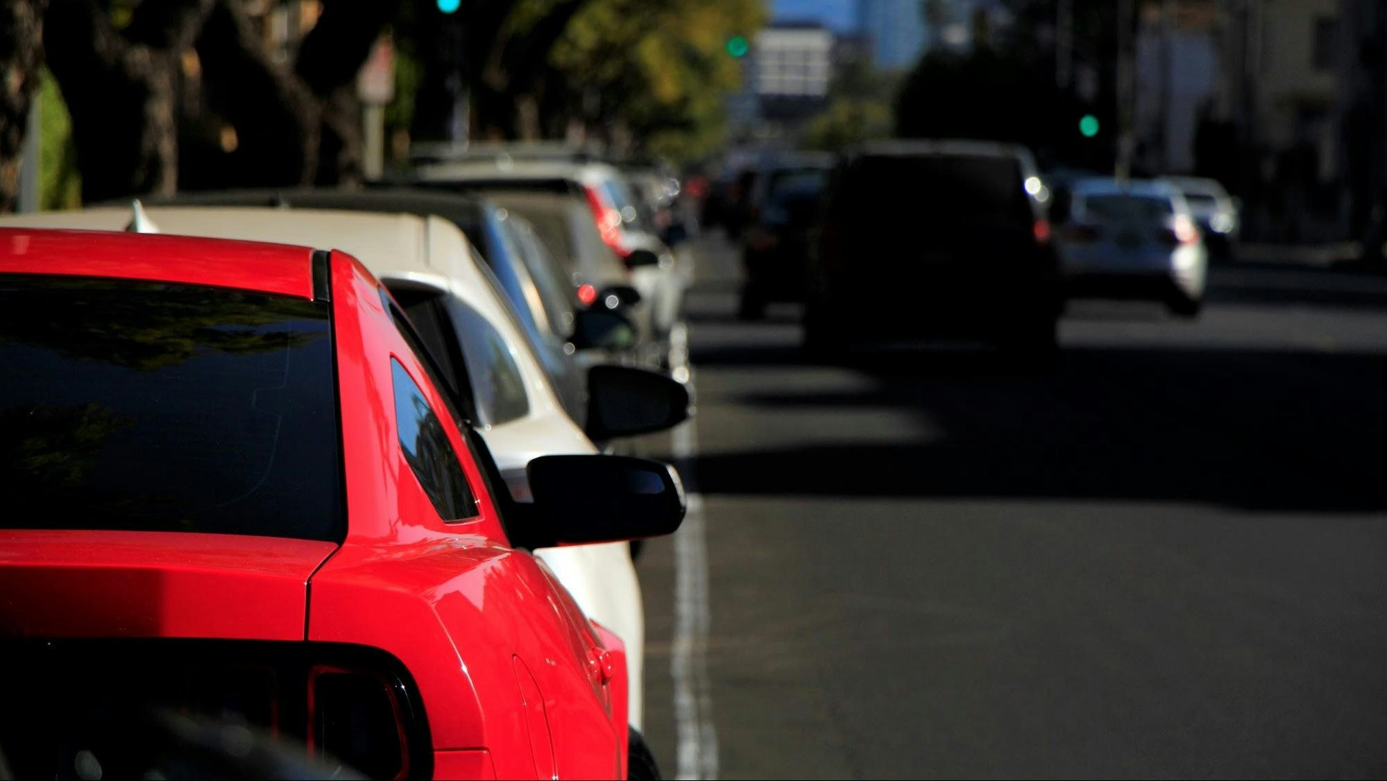 Vehicles parallel parked at the side of the road